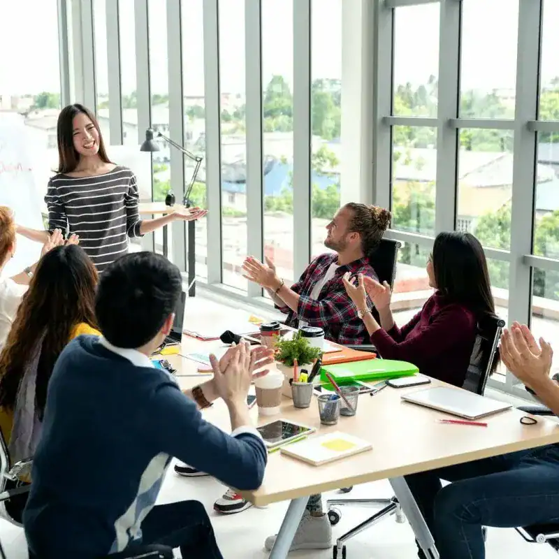 Facilitator guiding a small group through a structured workplace collaboration exercise